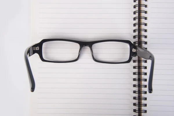 Gözlükleri. Gözlükleri ile arka planda kitap — Stok fotoğraf
