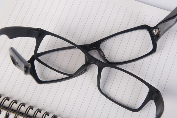 Anteojos. gafas de ojo con libro en el fondo —  Fotos de Stock