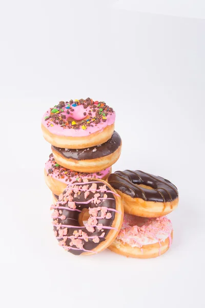 Donuts sortidos rosquinhas em um fundo — Fotografia de Stock