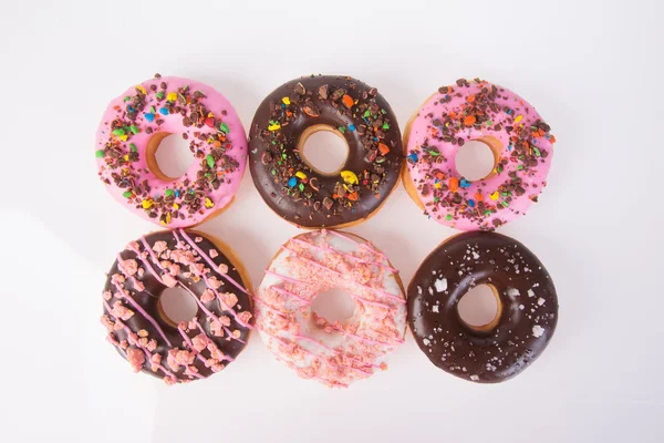 Donuts surtidos en un fondo —  Fotos de Stock