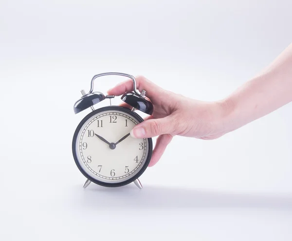 Alarm clock with hand. alarm clock with hand on the background. — Stock Photo, Image