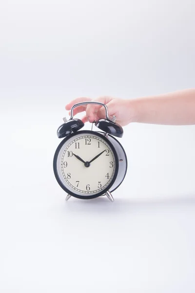 Alarm clock with hand. alarm clock with hand on the background. — Stock Photo, Image