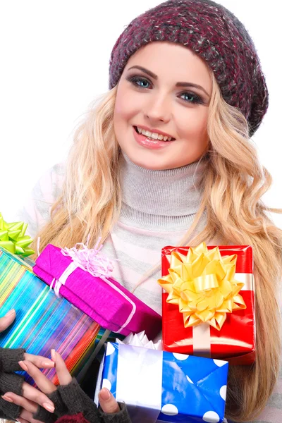 A photo of beautiful girl is in winter clothes with varicoloured gift boxes,  isolated — Stock Photo, Image