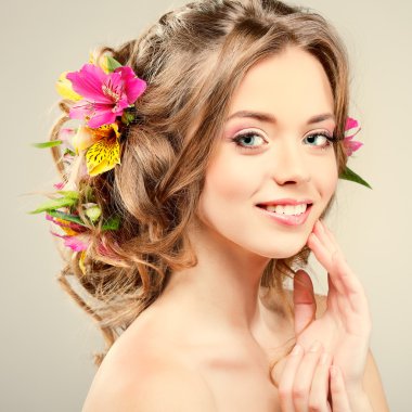 Beautiful  girl, isolated on a light - grey  background with varicoloured flowers  in hairs, emotions, cosmetics clipart