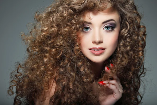 Young beautiful woman with long curly hairs — Stock Photo, Image