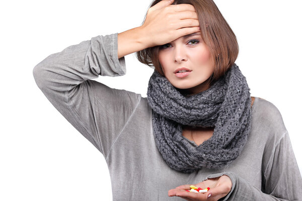 woman taking her temperature wile feeling sick and with fever, isolated on a white background
