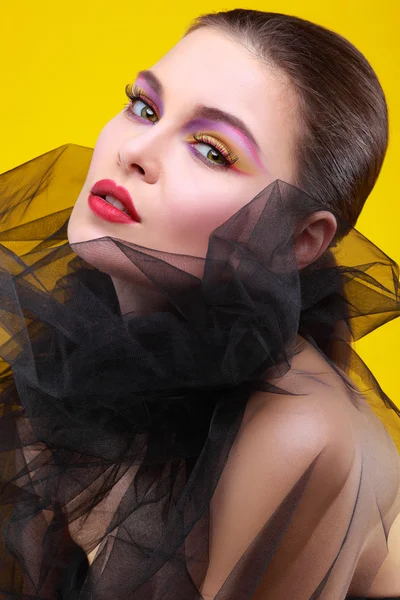 Portrait of sexual young girl in a black veil on a yellow background — Stock Photo, Image