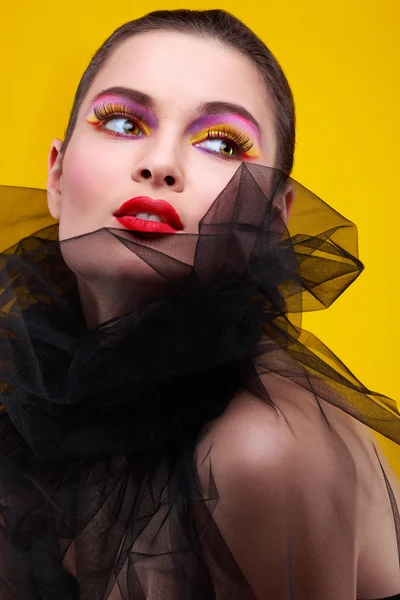 Portrait of sexual young girl in a black veil on a yellow background — Stock Photo, Image