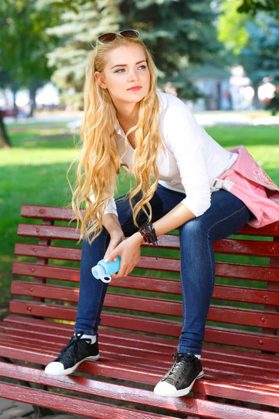 Portrait of beautiful girl with light long hairs in a park. — Stock Photo, Image