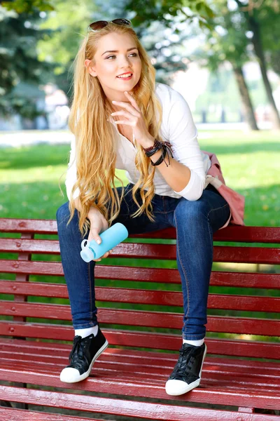 Portrait of beautiful girl with light long hairs in a park. — Stock Photo, Image