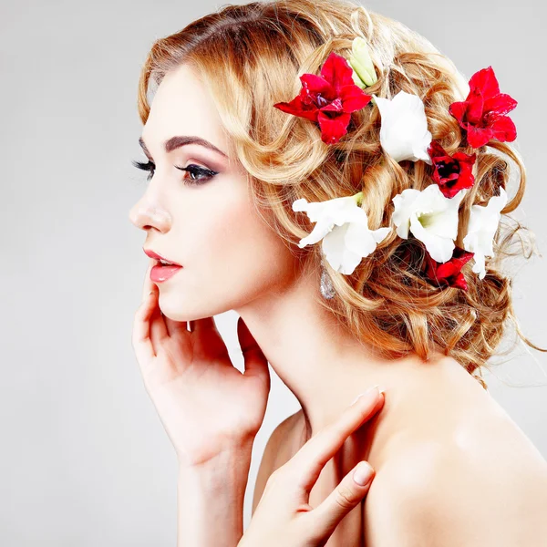 Beautiful  girl with varicoloured flowers — Stock Photo, Image