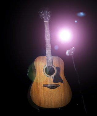 Acoustic guitar over black background clipart