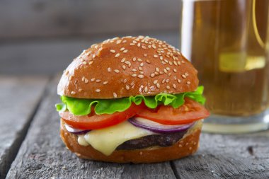 Ahşap masa bira taze ve sulu hamburger.