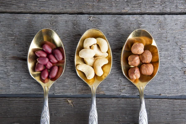 Mixed nuts in metal spoon — Stock Photo, Image