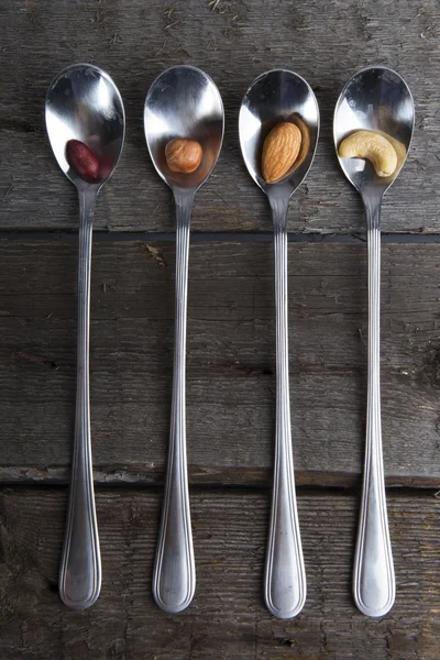 Mixed nuts in metal spoon — Stock Photo, Image