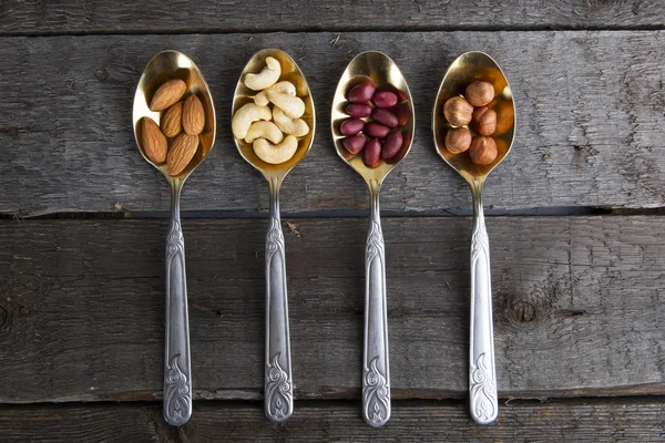 Mixed nuts in metal spoon — Stock Photo, Image