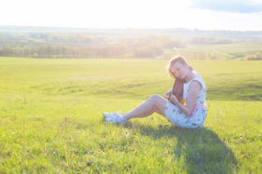 Güzel ve genç birbayan günbatımında gitar çalmak
