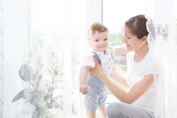 Happy family mother playing with newborn baby — Stock Photo, Image