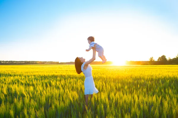 Happy family on nature outdoors mother and baby son — Stock Photo, Image