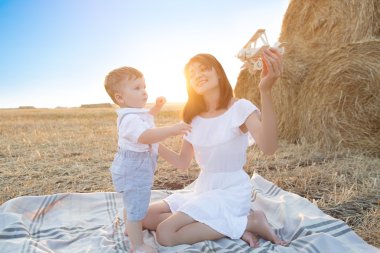 Woman and her son playing with toy airplane .