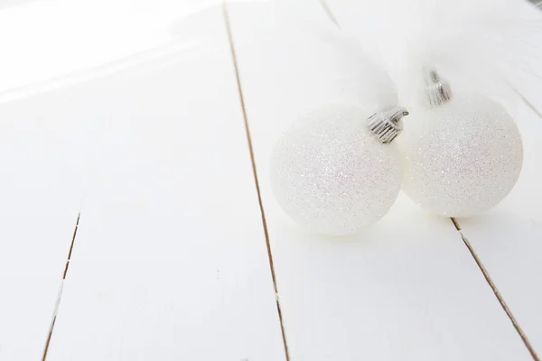 Two white christmas baubles on a background of wooden boards — Stock Photo, Image