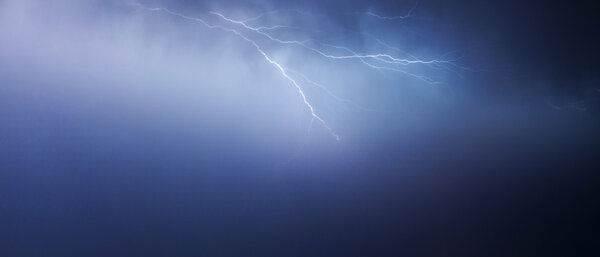 Huge fork lightnings and thunder during heavy summer storm.