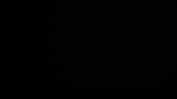 Flare of light or sun on dark black background — Stock Video