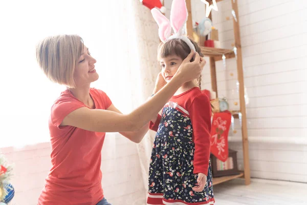 Mom and daughter dress up in a bunny costume for christmas — Stock Photo, Image