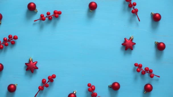 Mans hand fills wooden christmas background with fir branches, elderberries and christmas balls Royalty Free Stock Footage