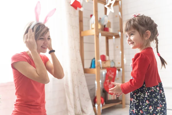 Mom and daughter dress up in a bunny costume for christmas — Stock Photo, Image