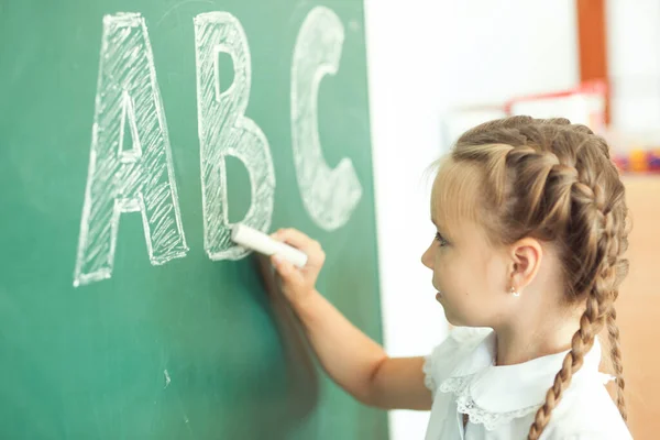 Young Girl Writing Abc Green Chalkboard — Stock Photo, Image