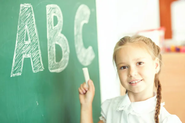 Young Girl Writing Abc Green Chalkboard — Stock Photo, Image