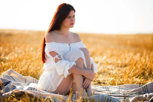 Summer is a great dream time. Sunny summer portrait of a beautiful young woman in the middle of a field.
