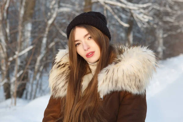 Young woman in winter. Winter woman on snowing cold winter day.