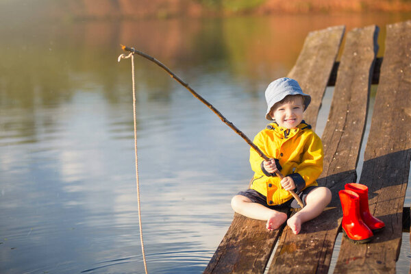 Handsome Young Kid Holding his Fishing Rod.