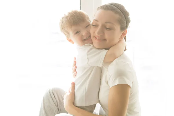 Beautiful Mother Her Cute Son Embrace Background Window House Concept — Stock Photo, Image