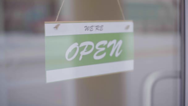 Cerrado por negocios debido a covid. Pequeña tienda pone cerrado firmar en escaparate — Vídeos de Stock