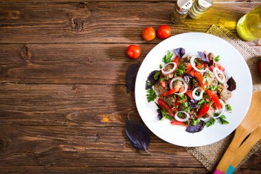 Kızarmış ciğer ve ahşap zemin üzerinde soğan ve domates..