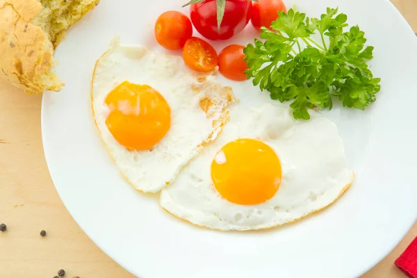 stock image Fried eggs with white bread on plate on wooden table