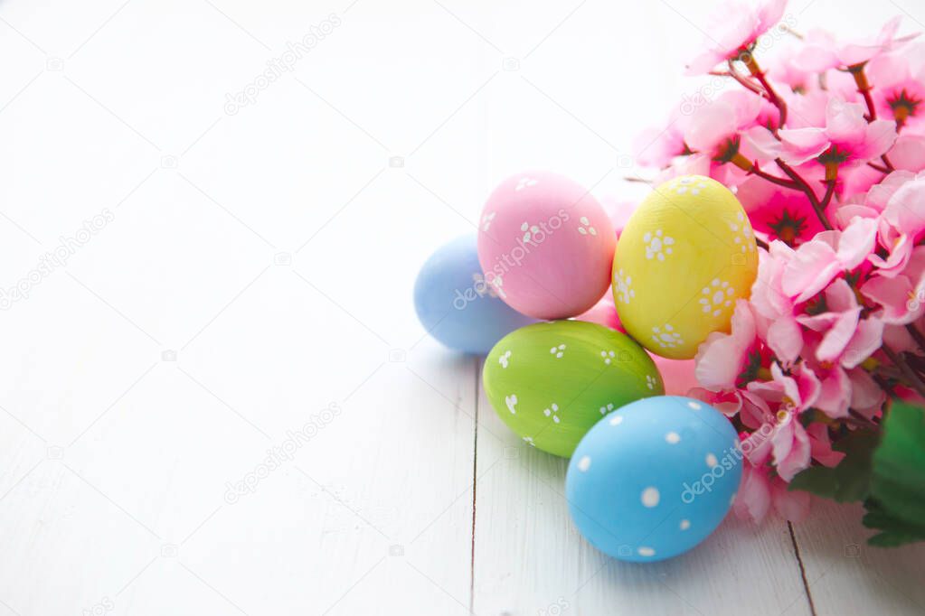 Colorful decorated easter eggs on white wood background. Happy Easter.