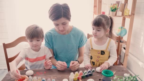 Щасливого Великодня. Сім'я з дітьми малює яйця на Великдень — стокове відео