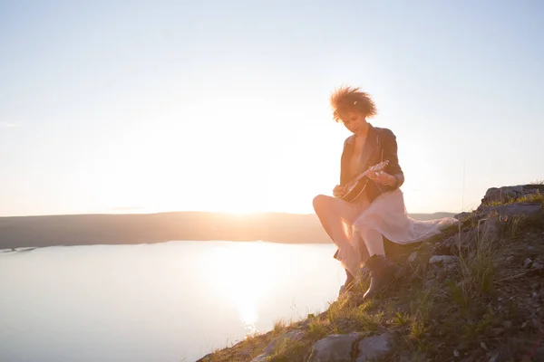 Frau mit Gitarrenukulele in den Bergen, traumhafte Landschaft, atemberaubend schöne Natur, Berge, Sonnenuntergang Wandern in den Bergen — Stockfoto