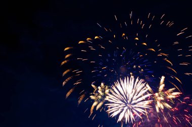Bulutlu gece gökyüzünün arka planında havai fişekler. 4 Temmuz - Amerikan Bağımsızlık Günü ABD