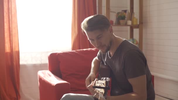 Человек играет на гитаре и поет — стоковое видео