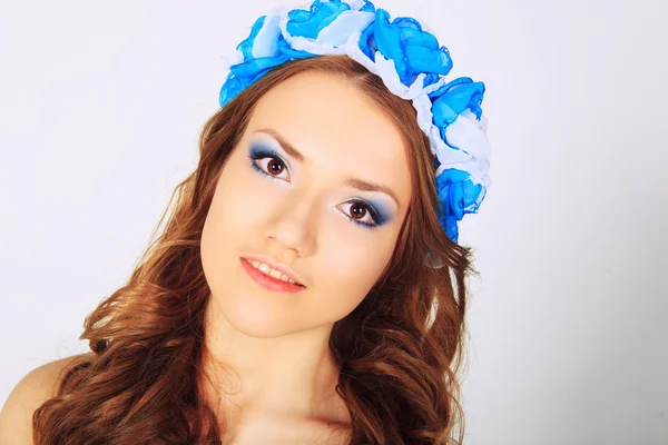 Beautiful young girl with flowers — Stock Photo, Image