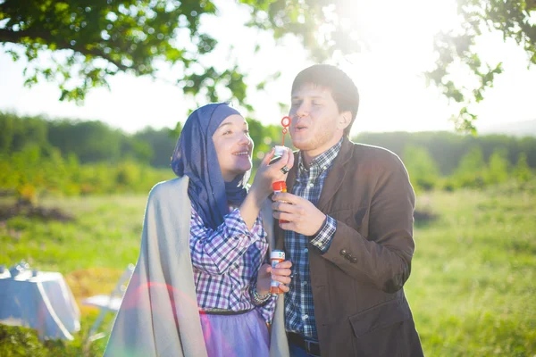 Couple playing around with bubbles — Stock Photo, Image