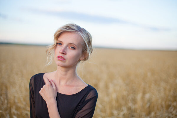 Beautiful woman standing in a grassy field