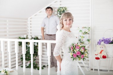 Genç gelin ve damat sevgiyle birbirlerinin gözlerine bakıyor