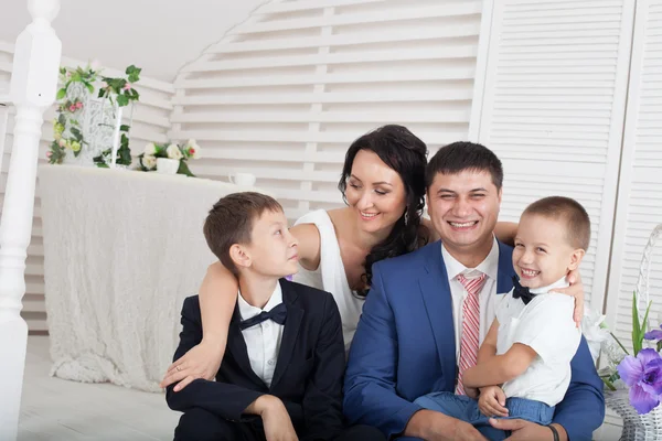 Happy parents sitting with their children — Stock Photo, Image