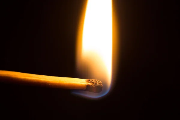 Burning matchstick on black background — Stock Photo, Image